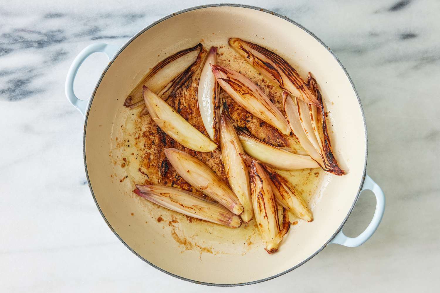 shallots pan-roasted in the dutch oven (after chicken is removed) for crispy chicken thighs with zucchini and shallots recipe
