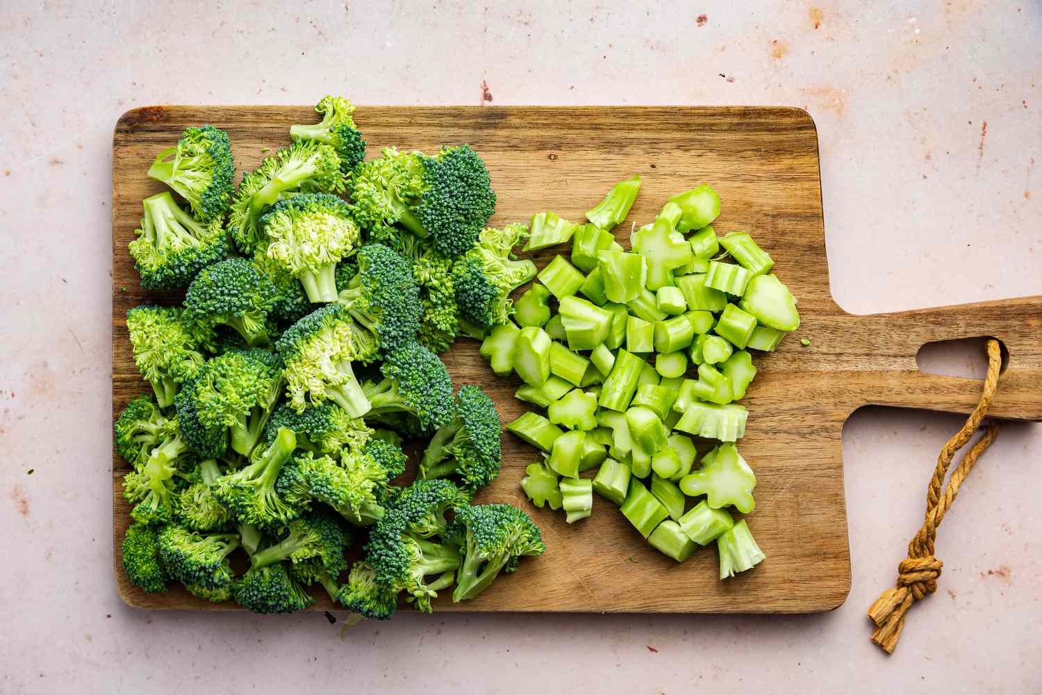 Broccoli Florets and Stalk Cut into Bite Size Pieces on a Cutting Board for Chicken and Broccoli Pasta Recipe
