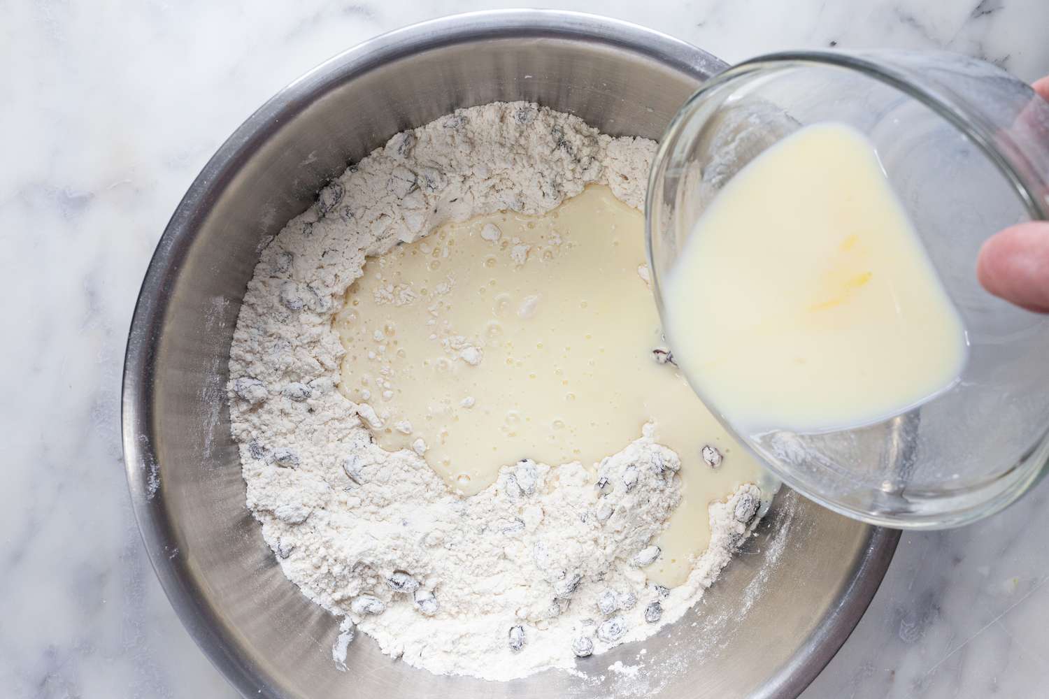 Irish Soda Bread with the wet ingredients added to a bowl of dry ingredients