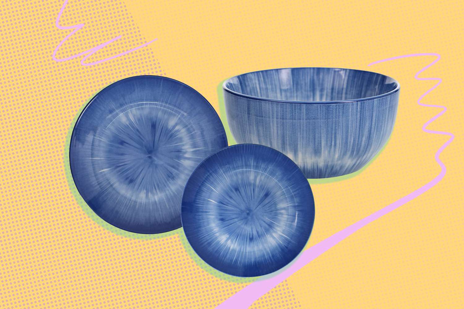 Three blue ceramic plates and a matching bowl presented on a yellow and pink abstract background