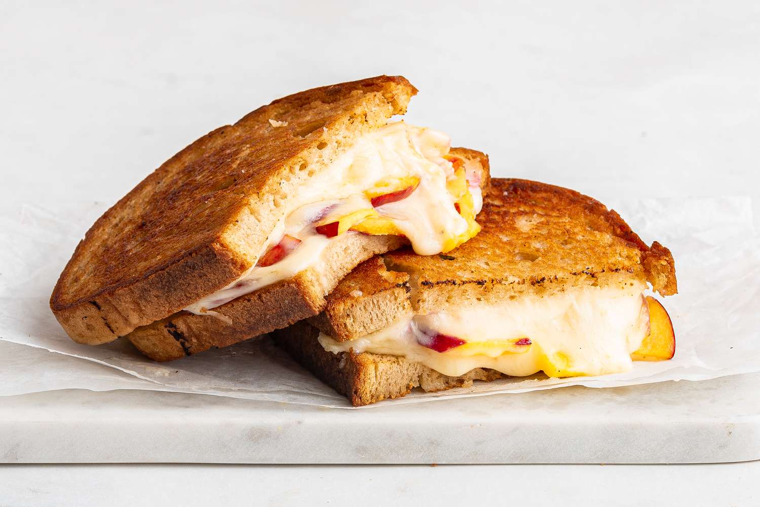 halved necatrine grilled cheese (one halve leaned on the other)