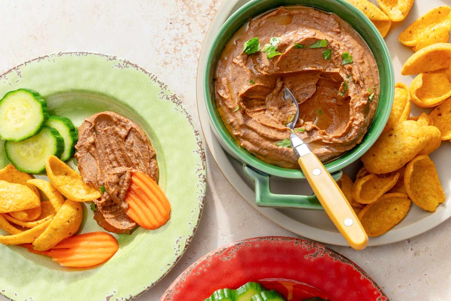 Black bean dip served with sliced vegetables and chips
