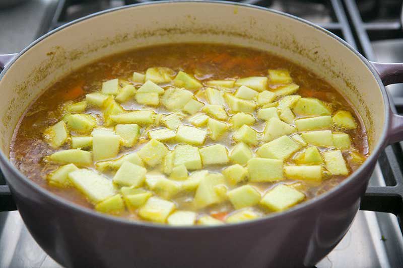 Chopped apples added to Mulligatawny soup