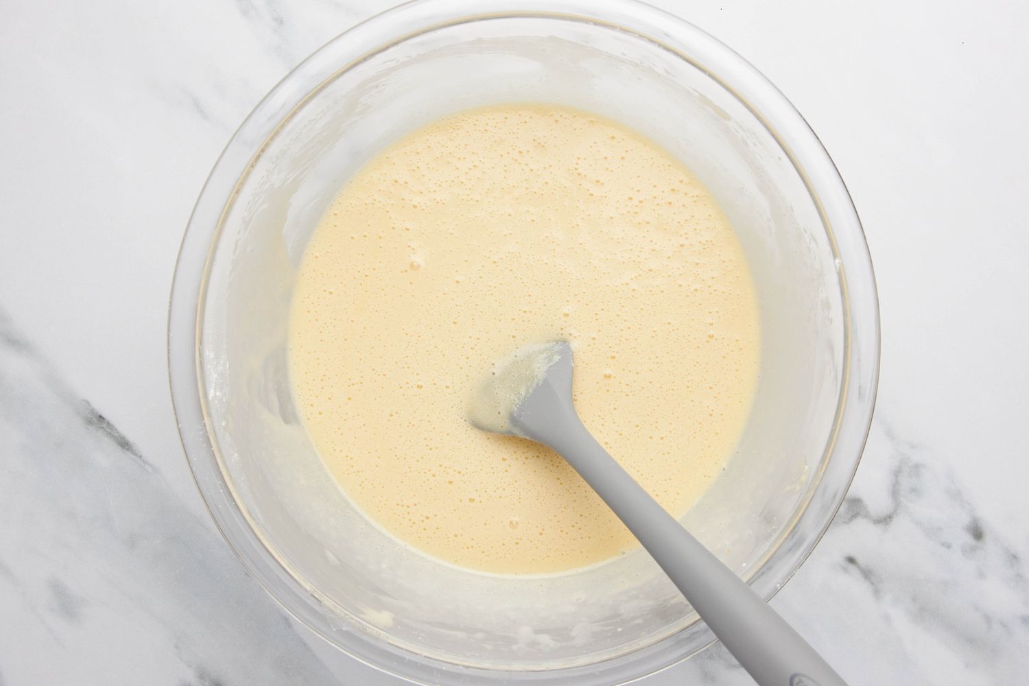 Lazy daisy cake batter in a bowl with a spatula