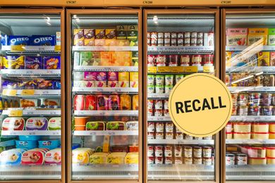 Grocery store freezer with various frozen items and a recall warning label