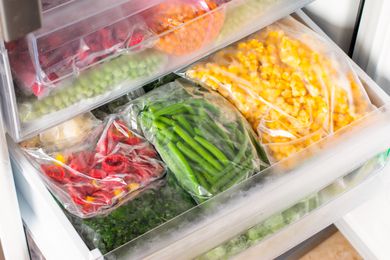 Assortment of frozen vegetables in an open freezer drawer