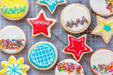 Royal icing for sugar cookies piped into a variety of patterns and sent on a cooling rack.