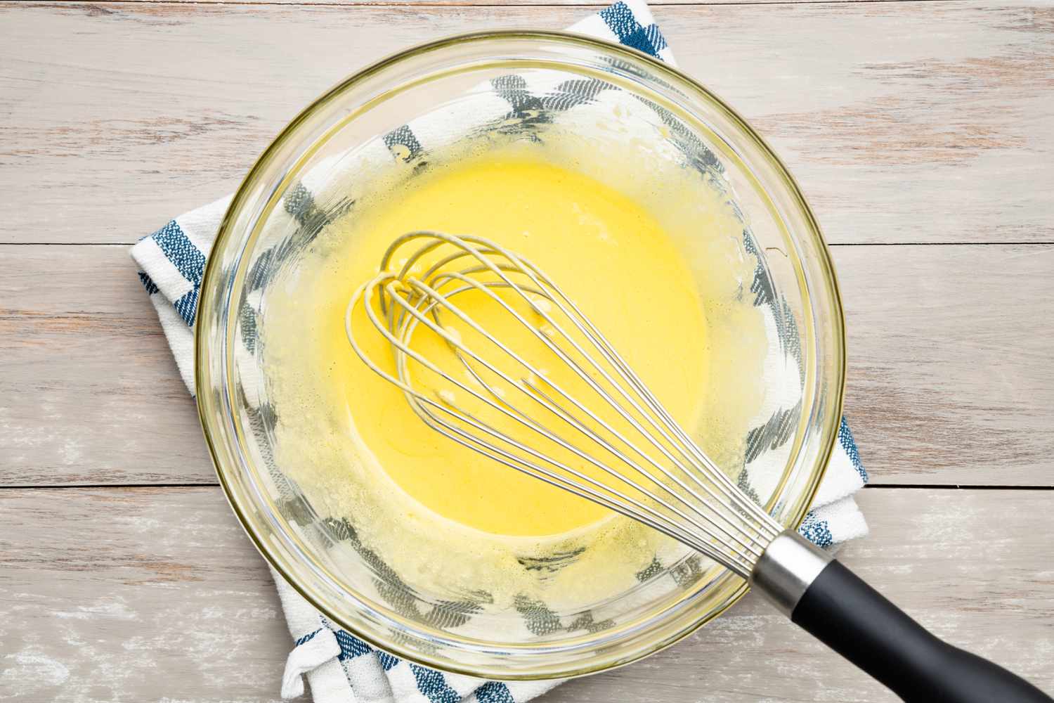 Bowl of Egg Whisked for Split and Scrapped Vanilla Bean on Cutting Board for Crème Anglaise Recipe