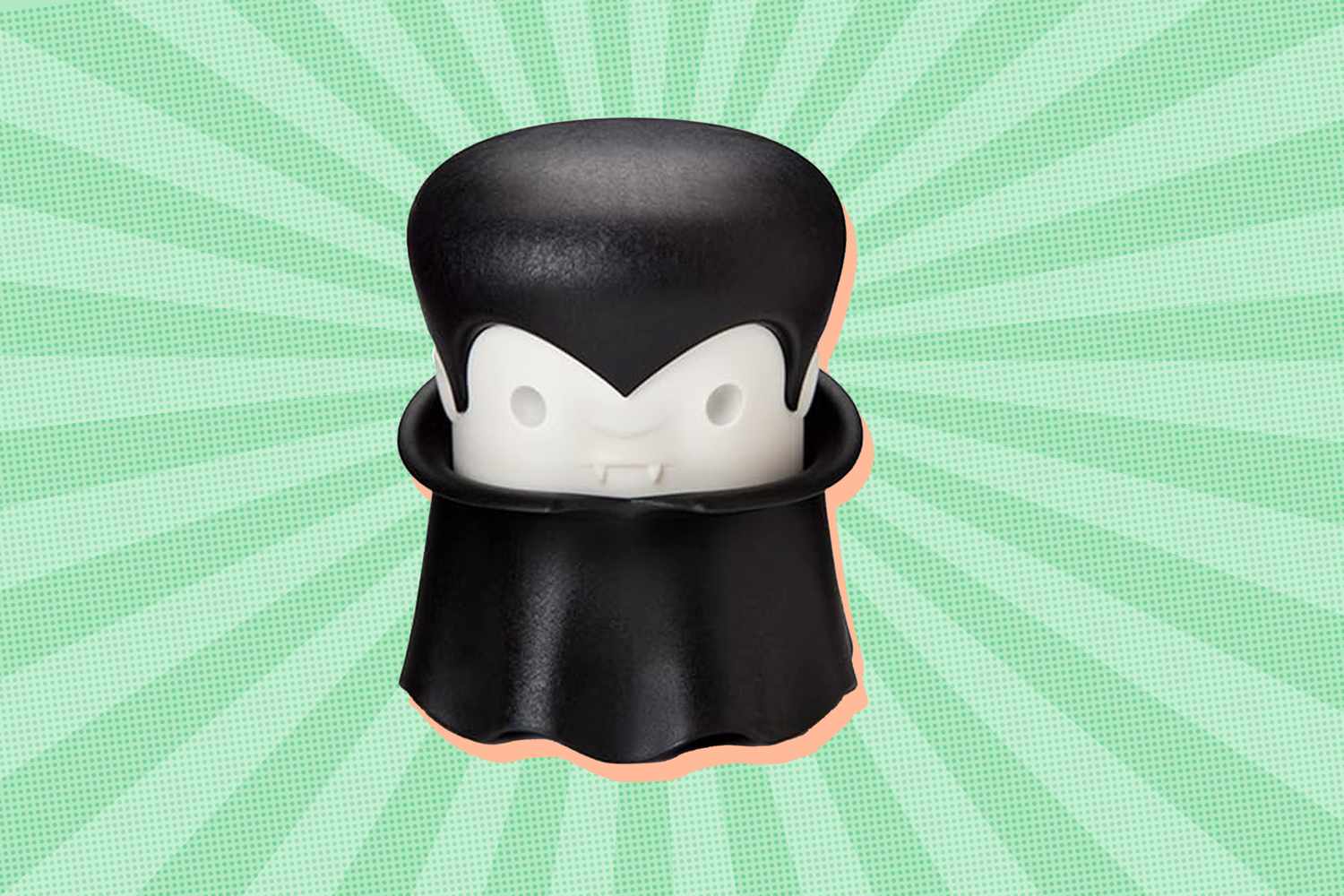 A Draculathemed garlic peeler against a green starburst background