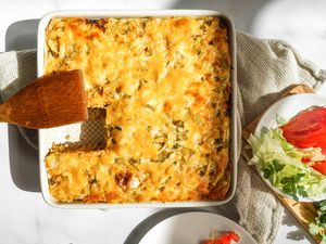 Baked burrito casserole with lettuce and tomatoes.