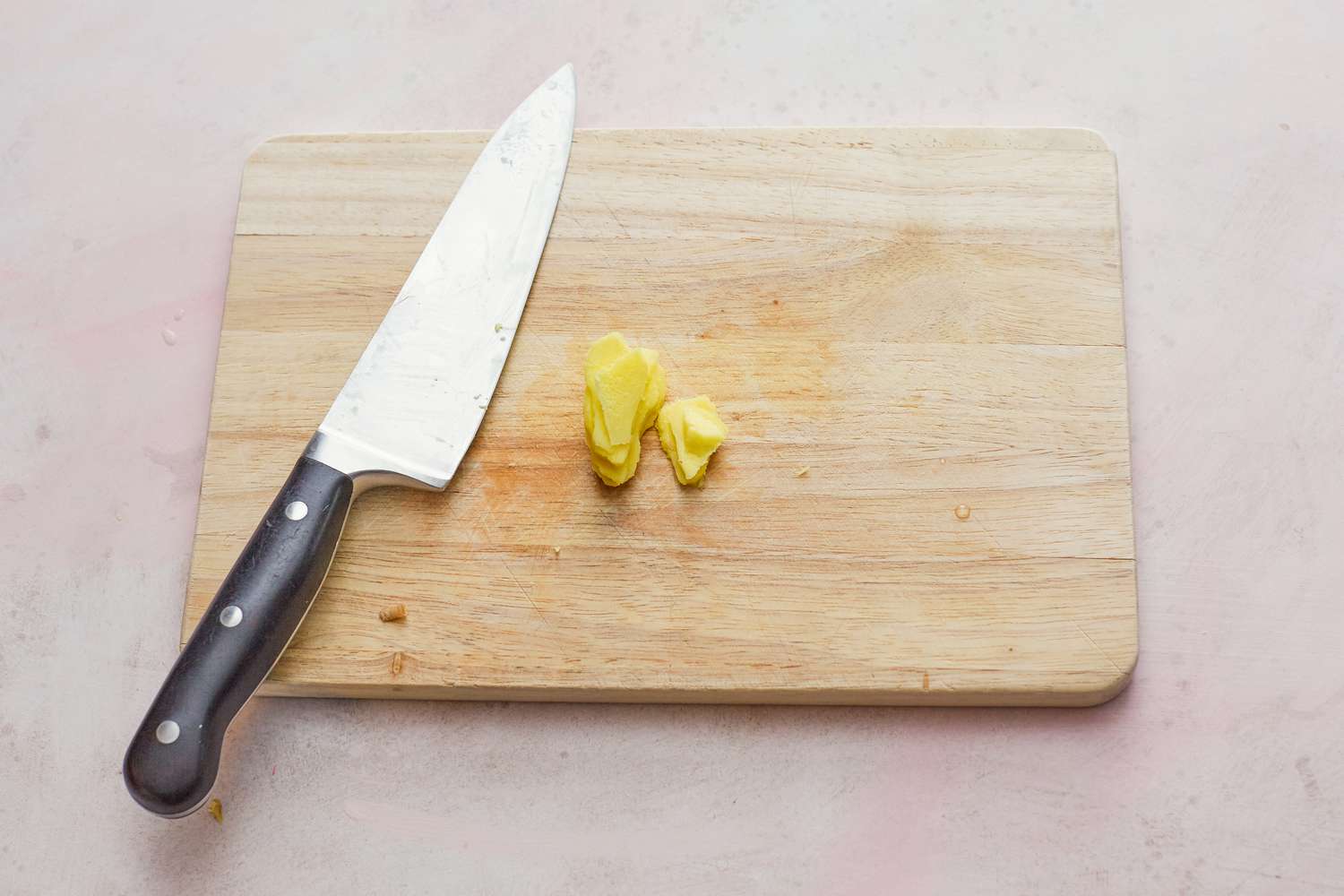 Prepping ginger with a chef's knife to make whole steamed black sea bass