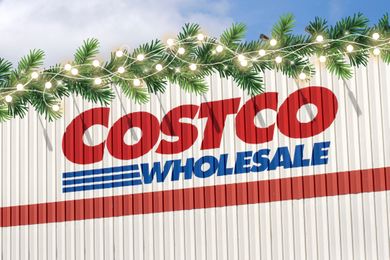 Costco Wholesale storefront with light string and festive greenery on top