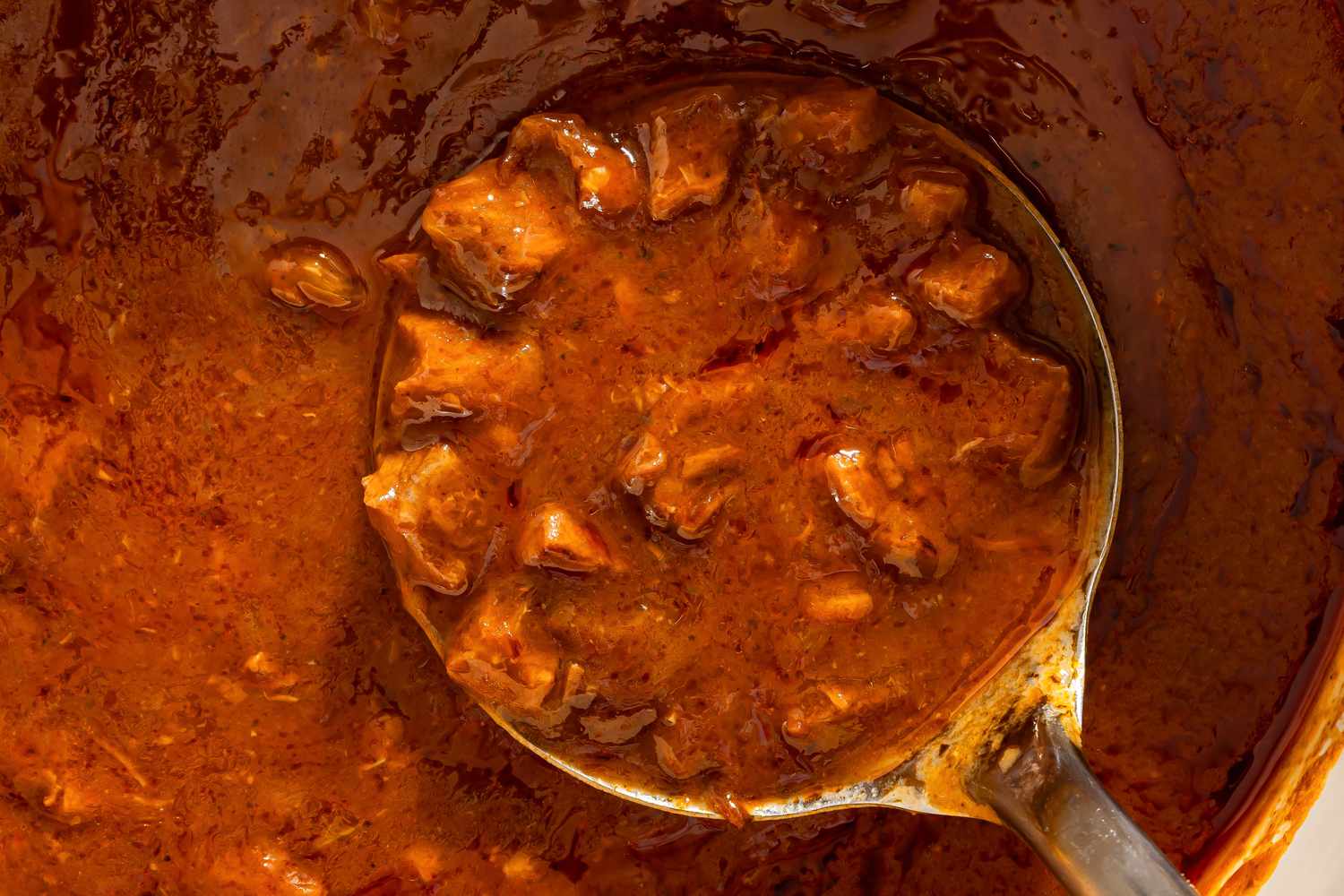 close up view of a ladle of Grandma Helen’s Beefy Tomato Soup