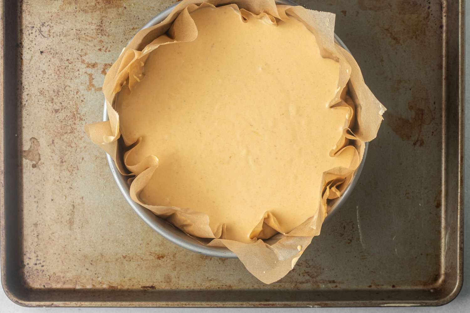 Overhead view of basque-style cheesecake in a pan and ready to be baked.