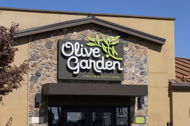 The front of an Olive Garden restaurant showing its sign and entrance