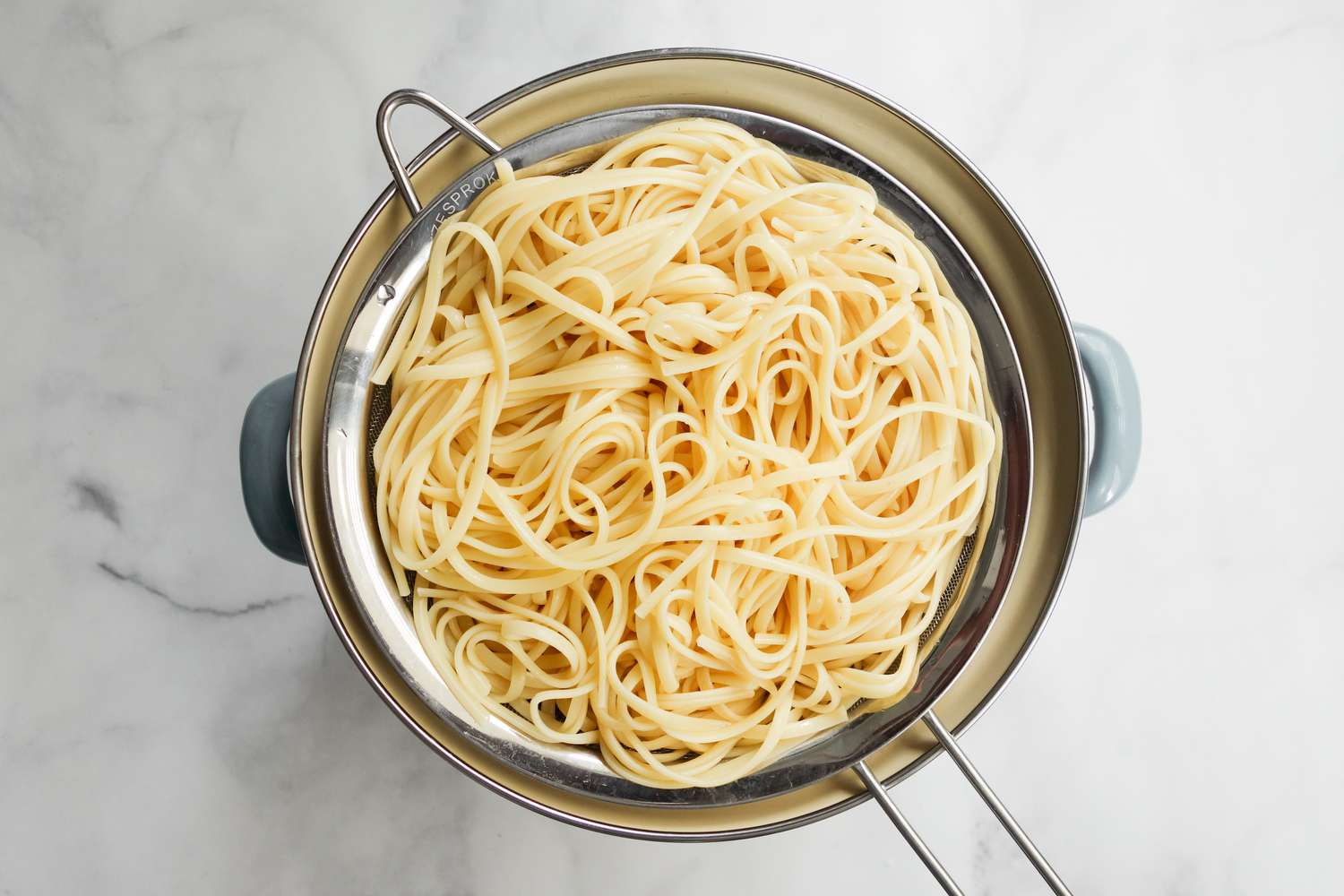 Cooked Linguine in a Colander for Spicy Creamed Corn Linguine Recipe