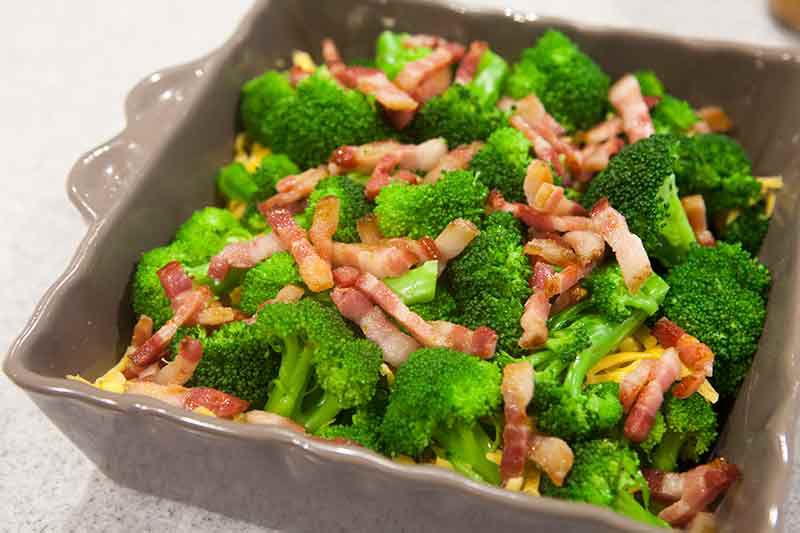 broccoli cheese casserole with bacon in baking dish