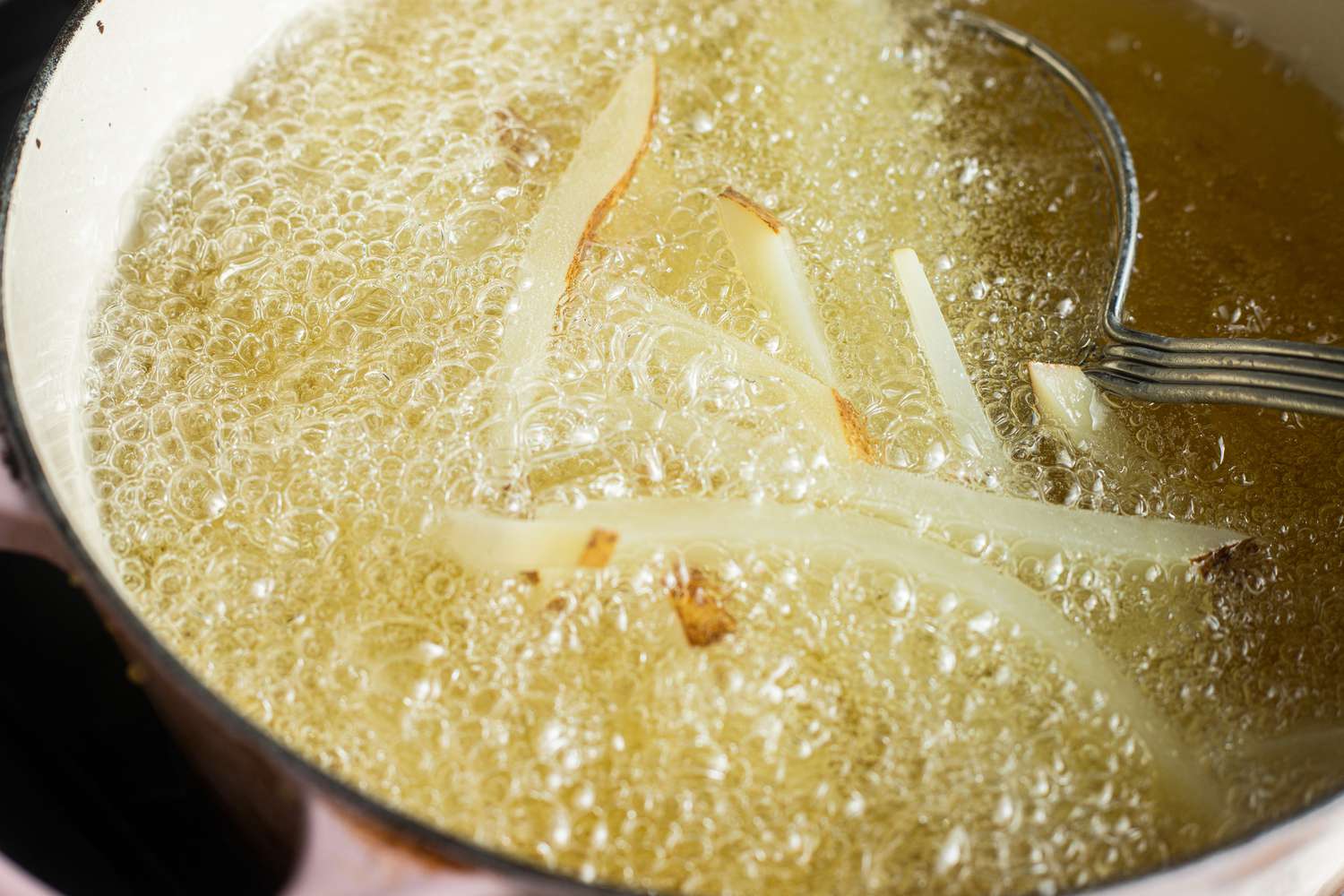 French Fries Frying in Pot of Oil