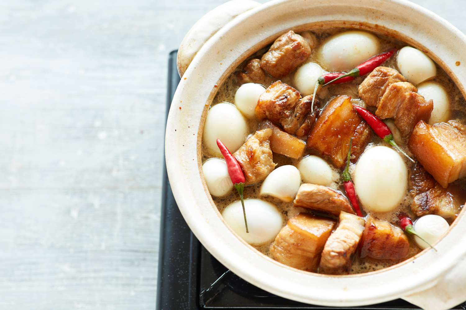 A pot of pork belly and eggs braised in sweet coconut water