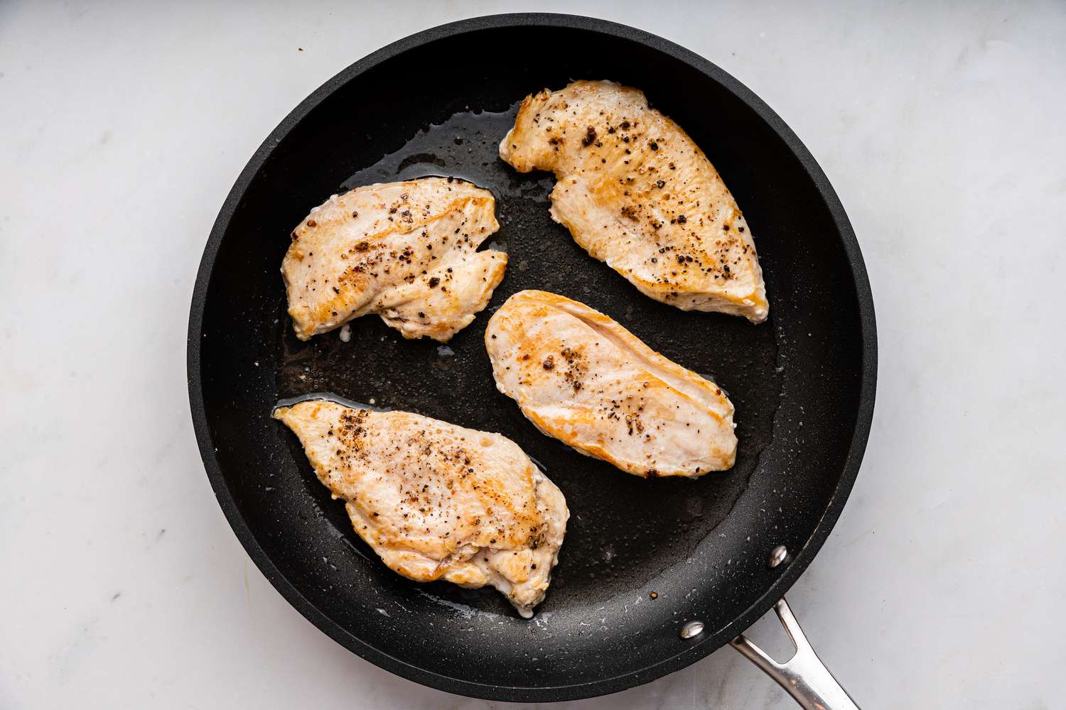 chicken seared in a pan for easy chicken primavera recipe