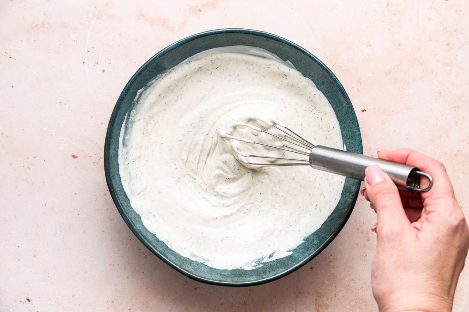 whisking creamy dill sauce for pickle pizza