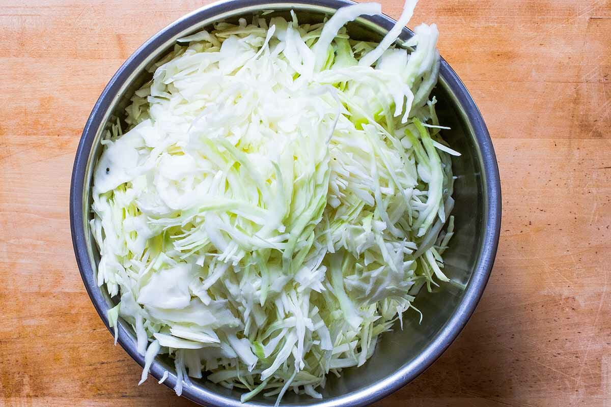 thinly sliced cabbage in a bowl