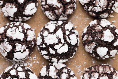 Overhead view of chocolate crinkle cookies on a lined baking pan