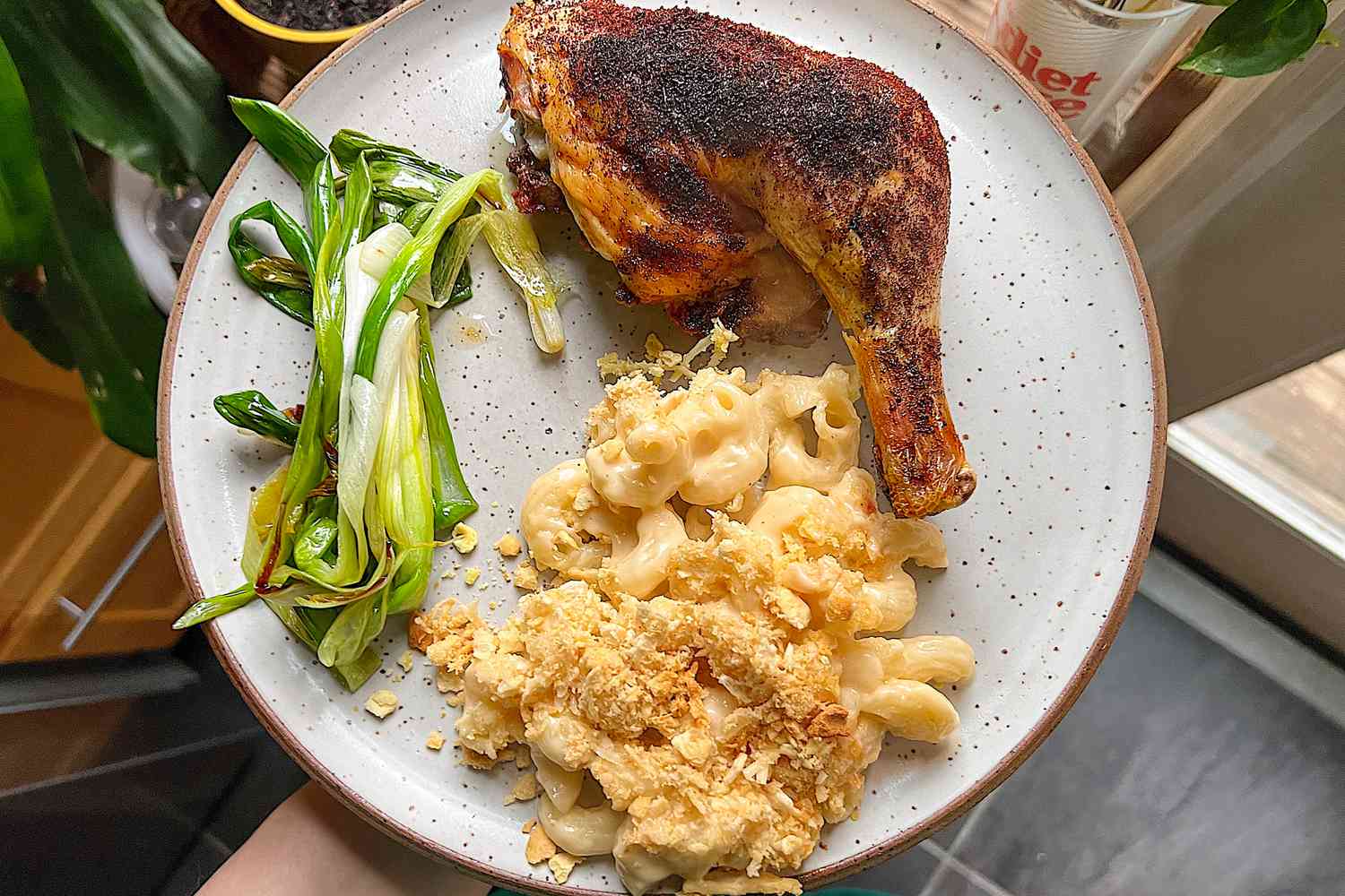 Skillet scallions on a plate with chicken and mac and cheese