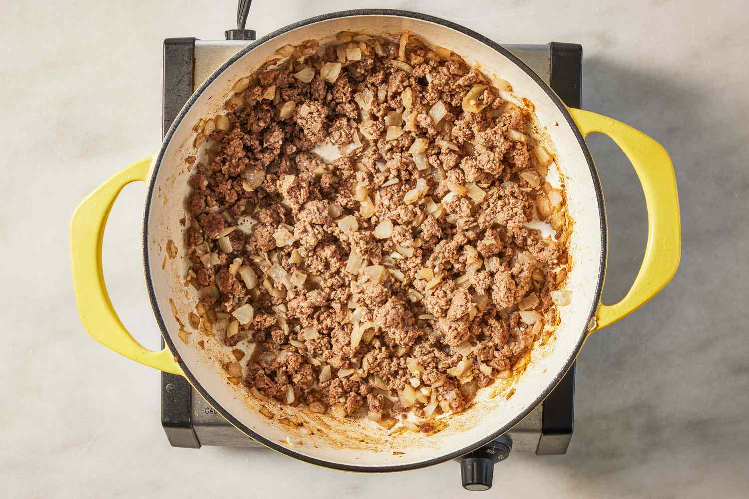 ground beef cooking in a pan for salisbury ground beef recipe 