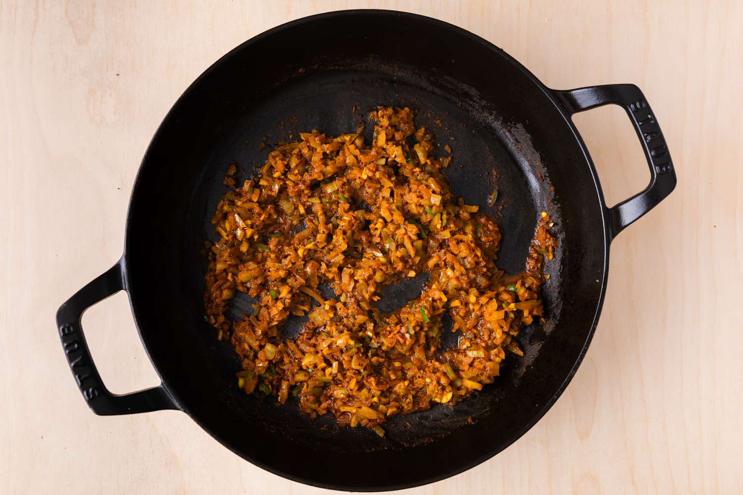 seasoning, onion, pepper, ginger and garlic mixture being pan fried for Bombay Aloo (Bombay Potatoes)