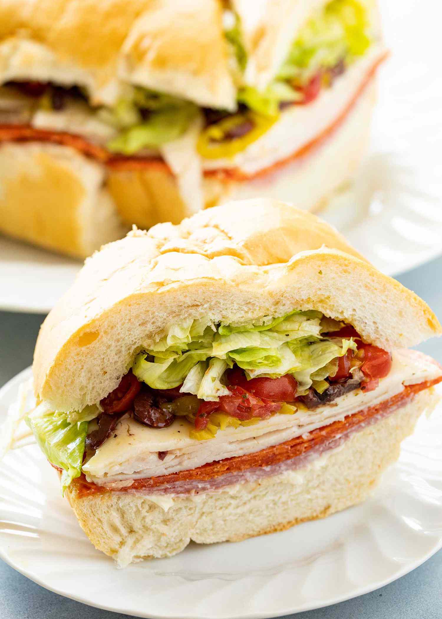 Italian sandwich for a crowd with the meat, cheese and toppings visible.