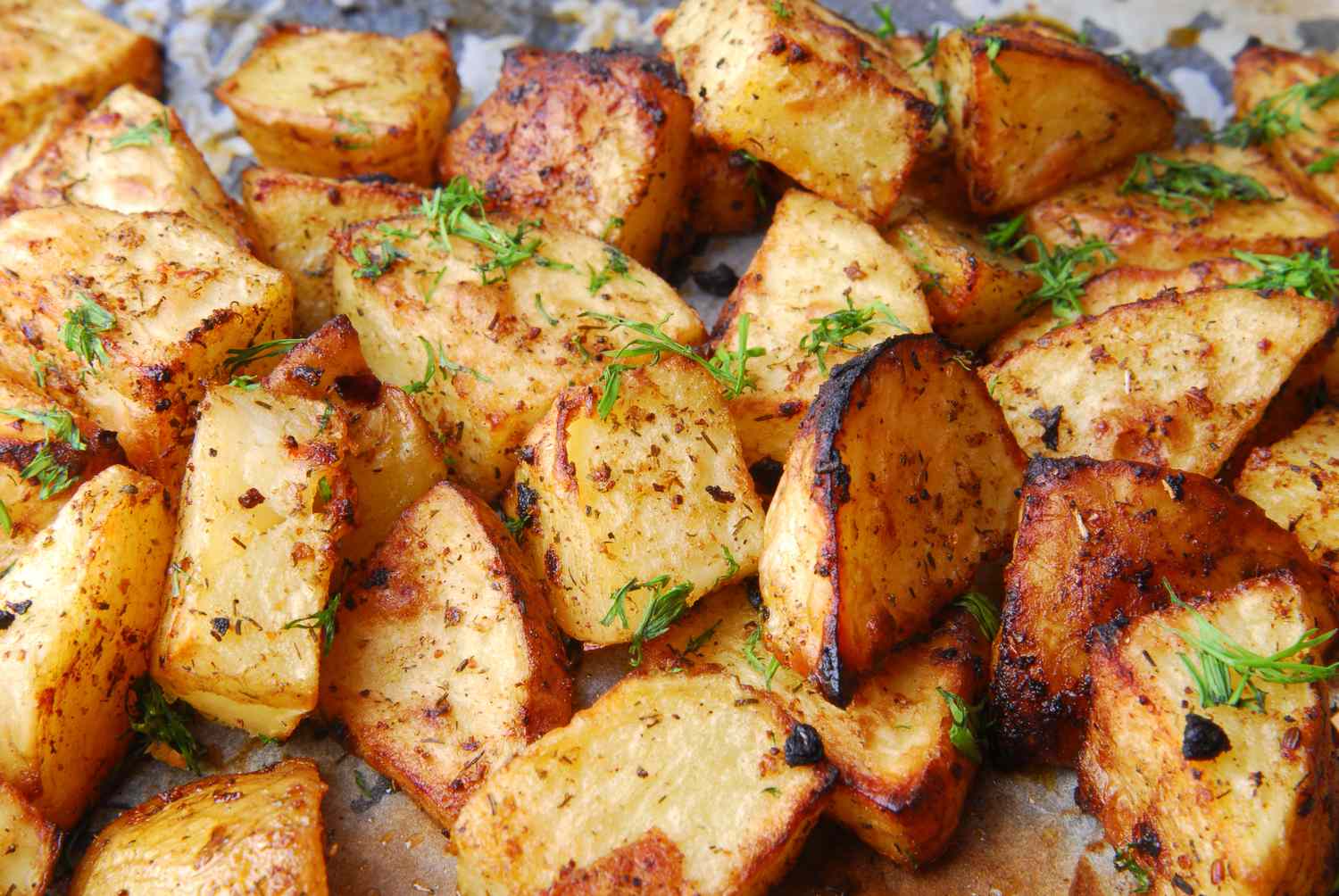 Roasted potato wedges garnished with herbs