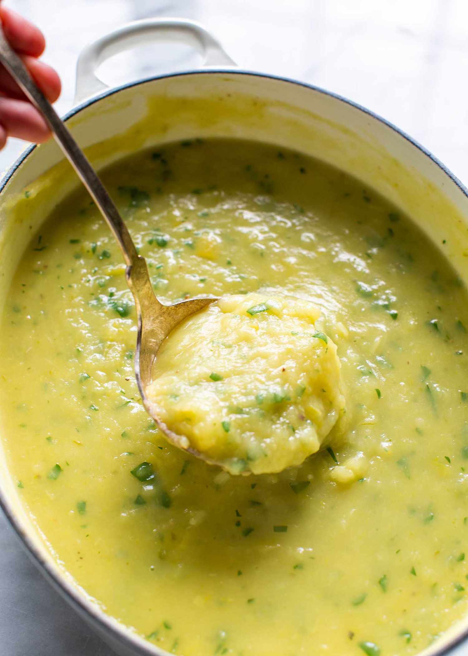 Potato Leek Soup Recipe with spoon lifting out of bowl