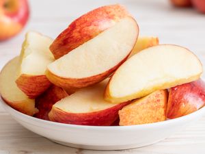 A bowl of sliced apples on a table