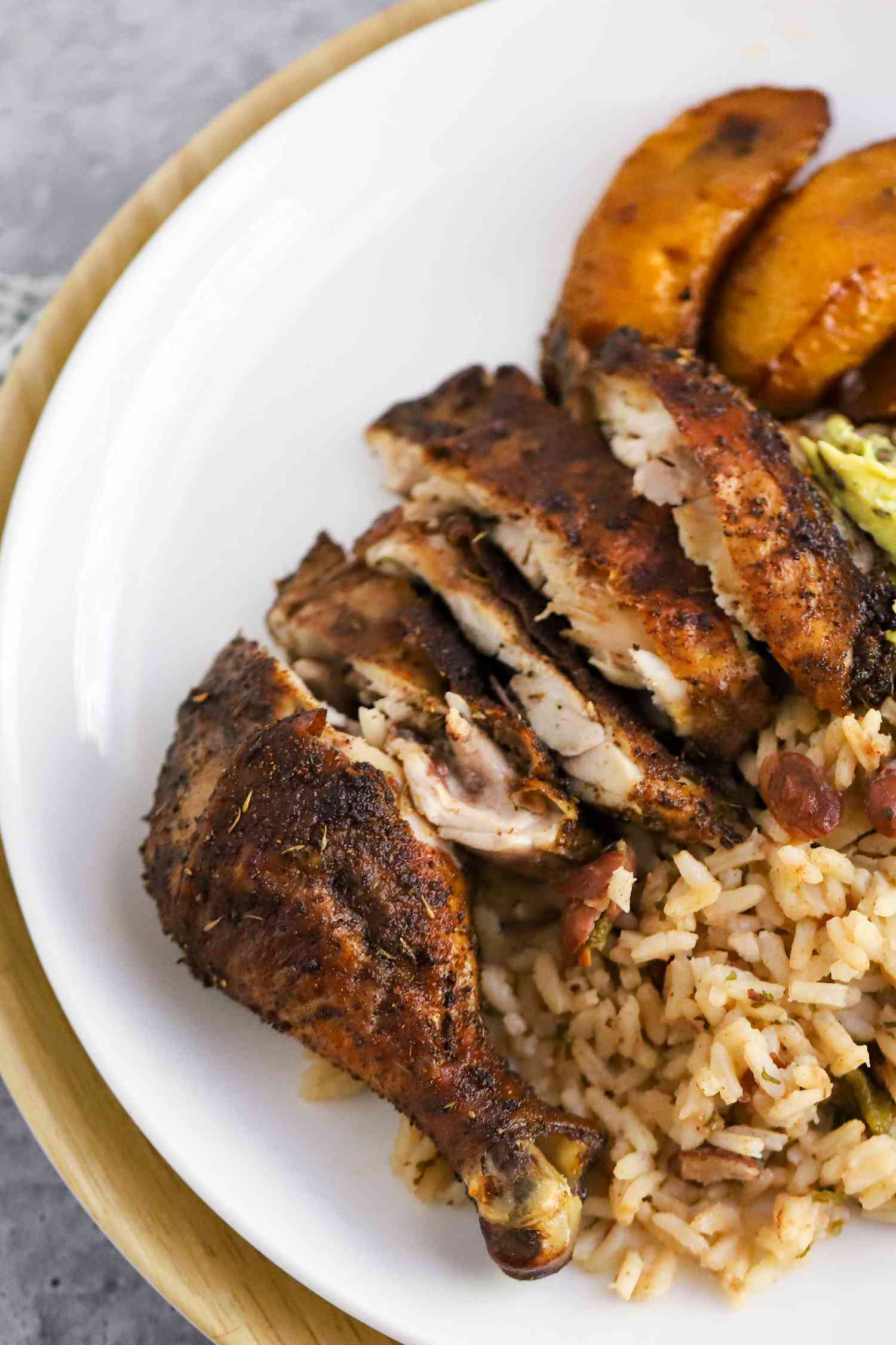 Jerk Chicken Sliced Into Pieces and Served With Rice and Sliced Plantains