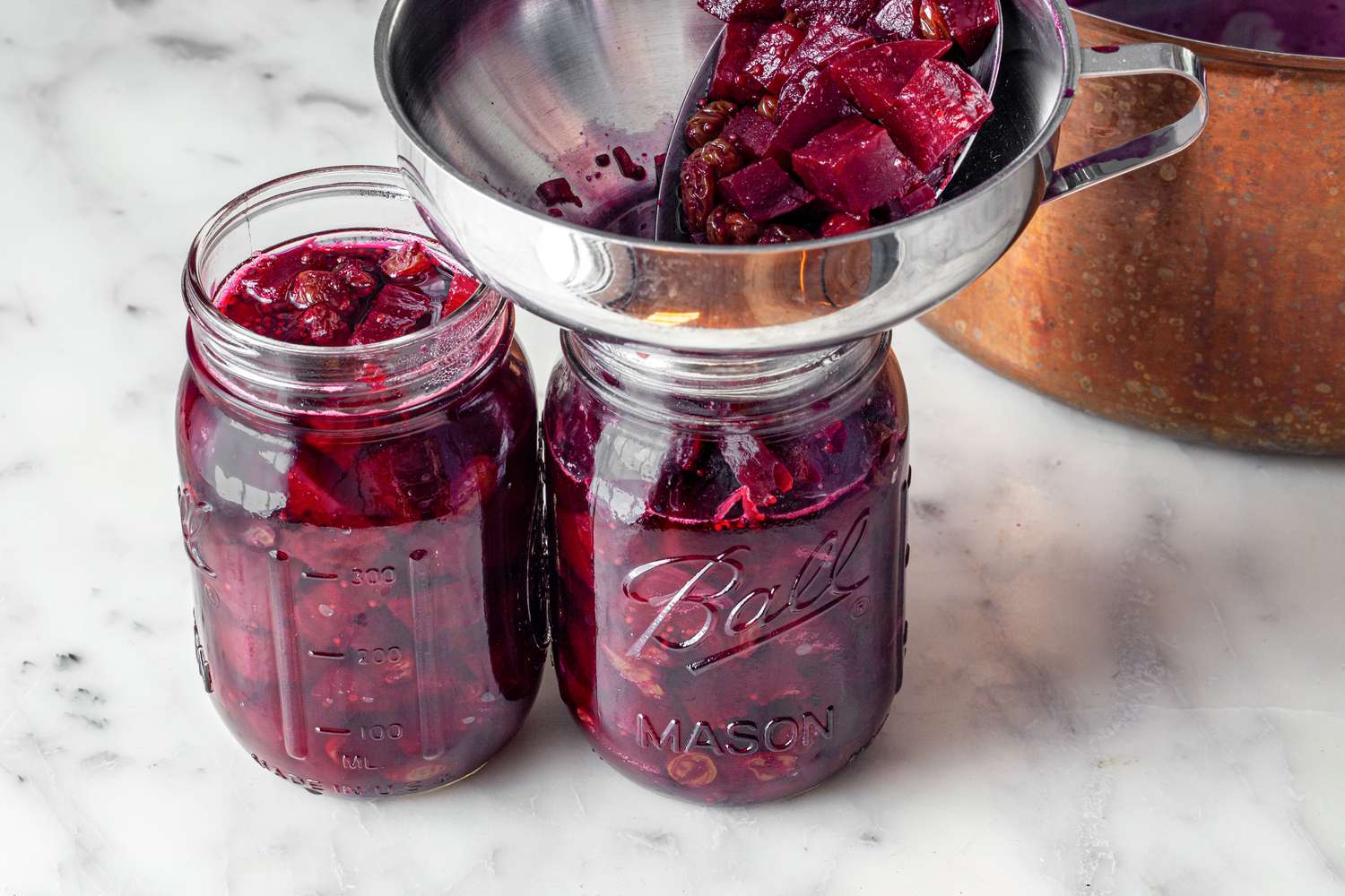 Beet Chutney Funneled into Jars