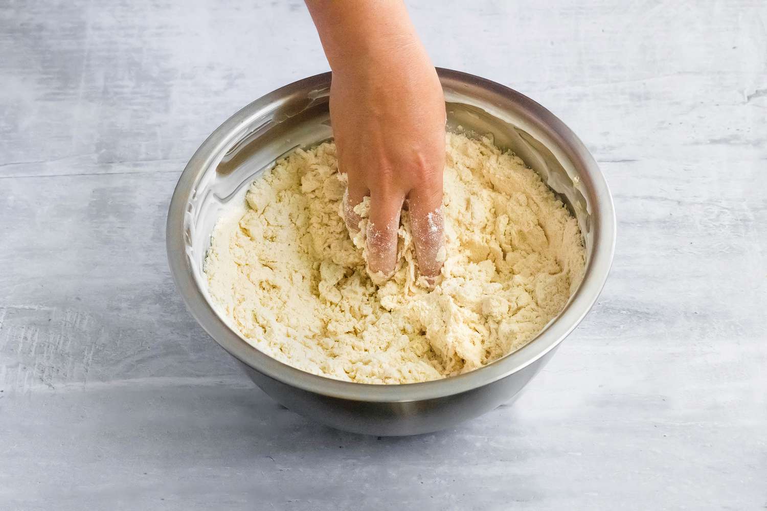 Dry Masa (Tamales Dough) Ingredients Hand Mixed into Lard, Creating a Wet Sand Consistency