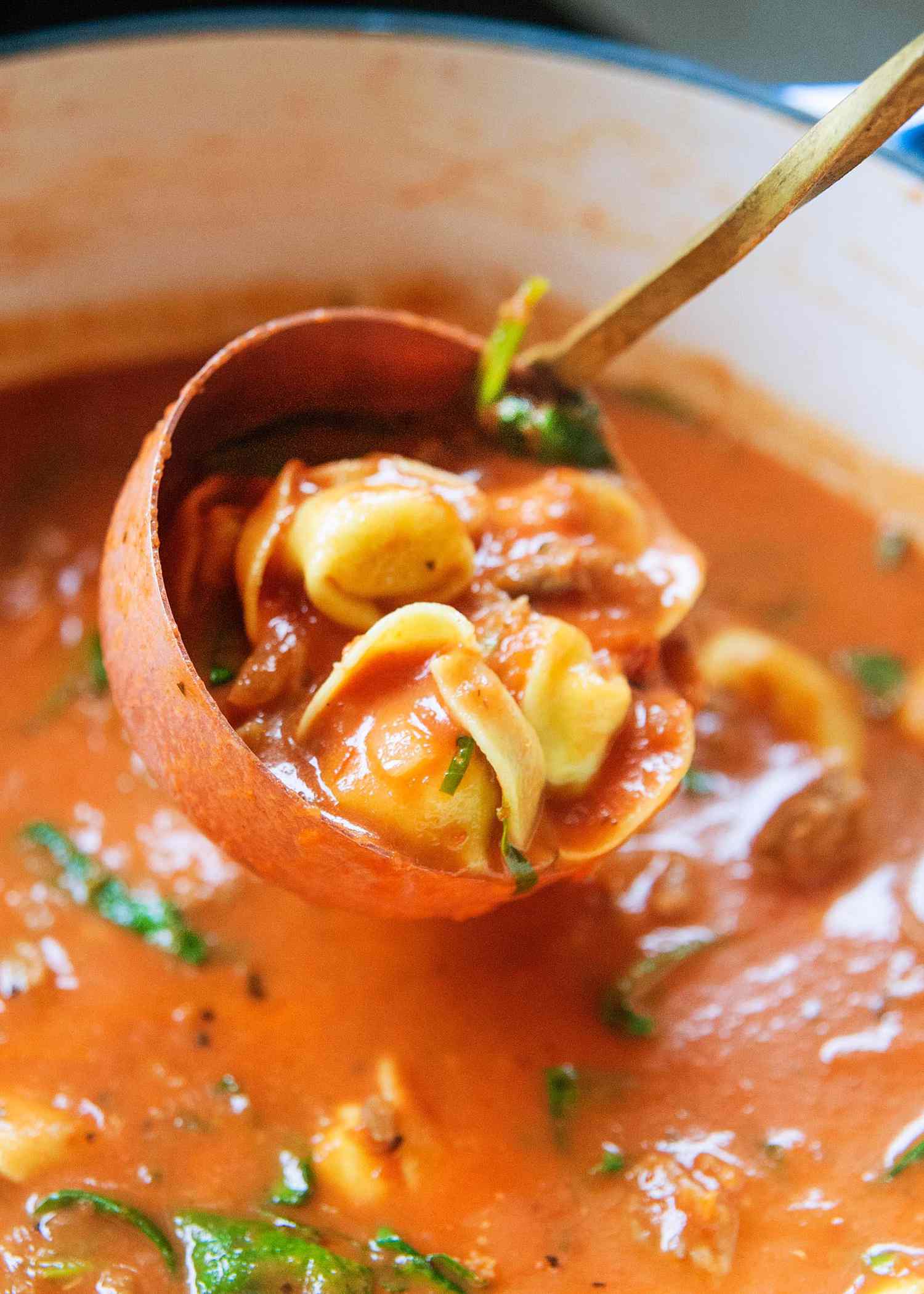 Italian Sausage Soup - ladle of soup being lifted from the pot