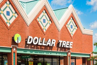 Exterior of a Dollar Tree store with a brick facade and decorative motifs on the roofline