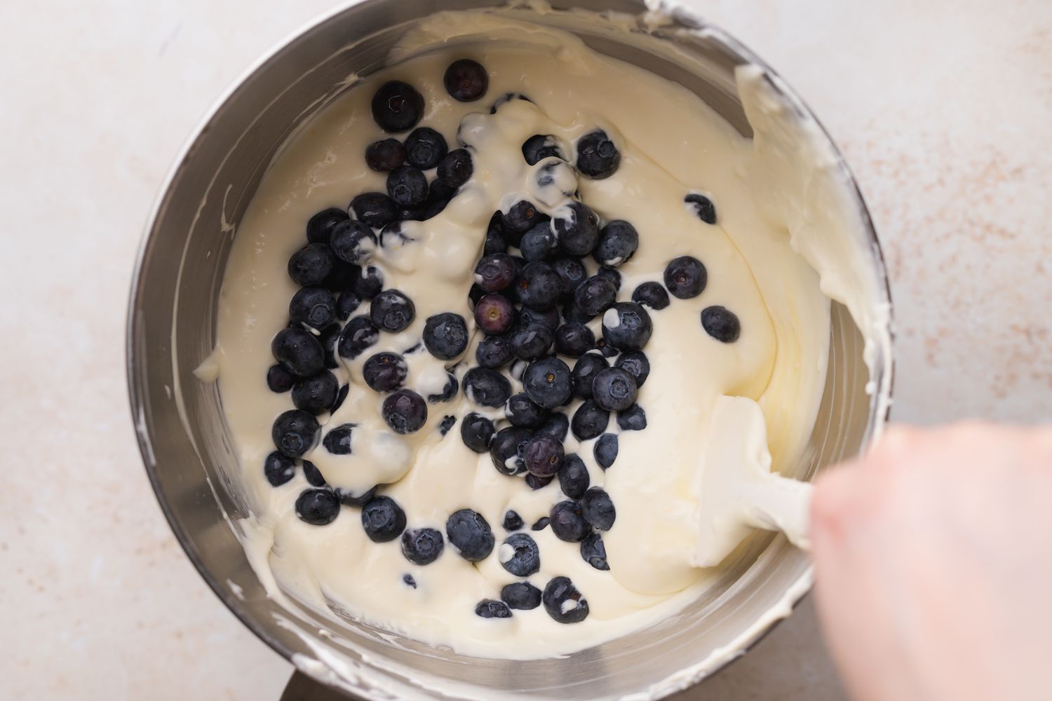 Fold blueberries into cheesecake mixture.