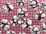 Chocolate crinkle cookies on a hot pink cooling rack