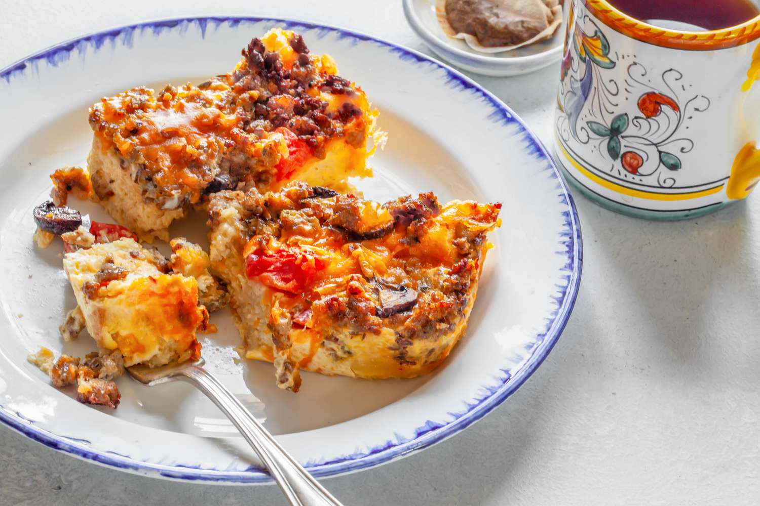 Slices of Sausage Breakfast Casserole on a Plate with Some on a Fork