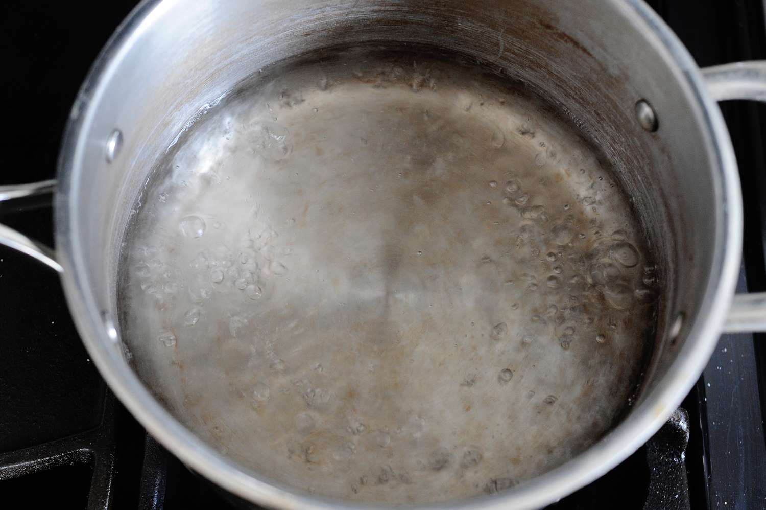 Simmering sugar syrup to make Strawberry Seven-Minute Frosting.
