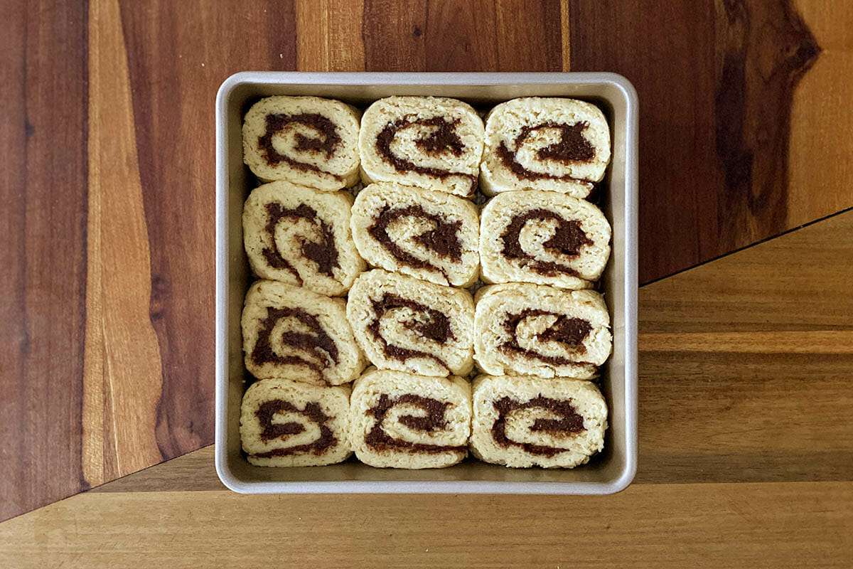 Unfrosted Easy Gluten Free Cinnamon Rolls set in a baking pan.