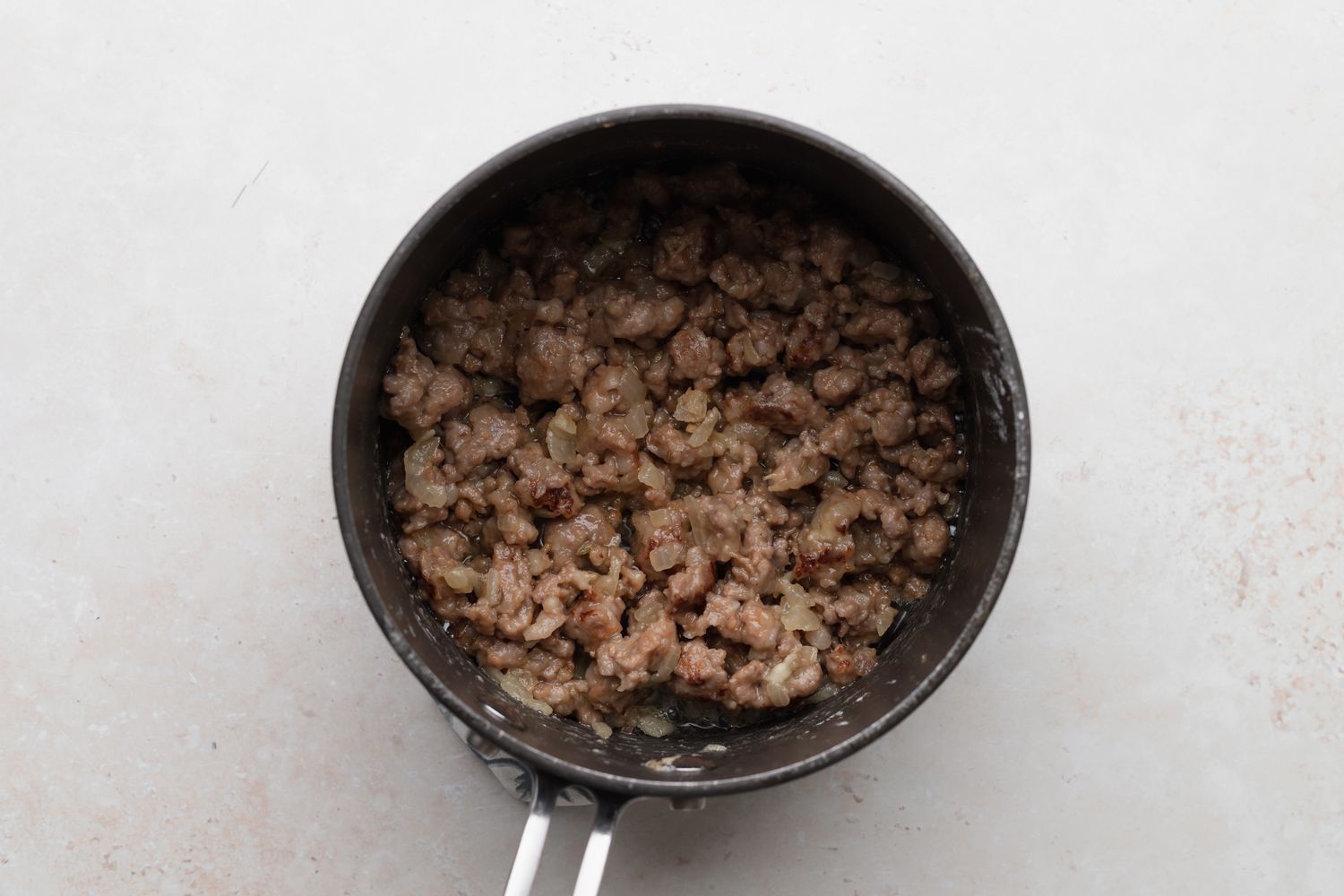 Making sausage gravy for a biscuits and gravy recipe.