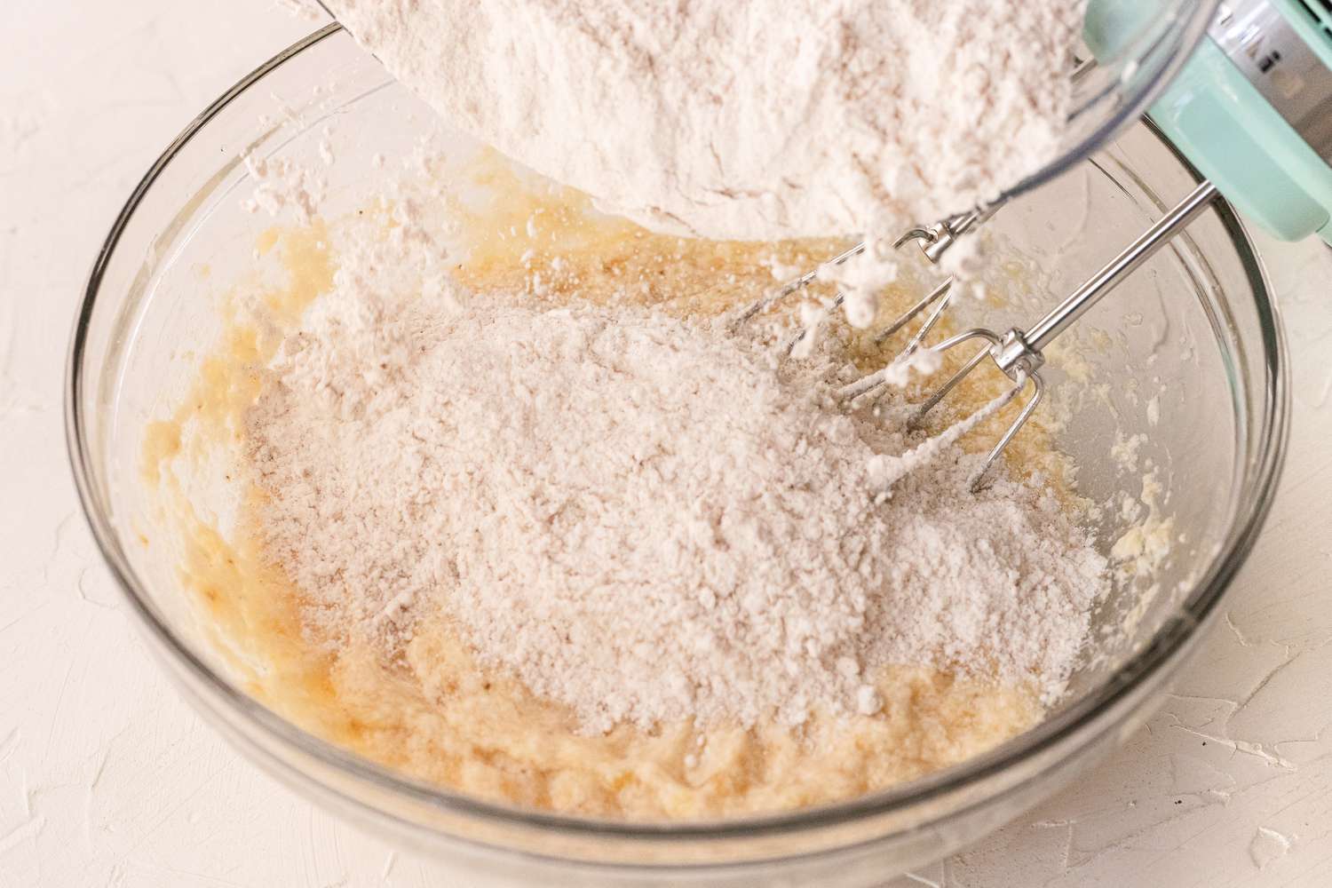 Dry ingredients added to a bowl to make the batter for banana cookies.