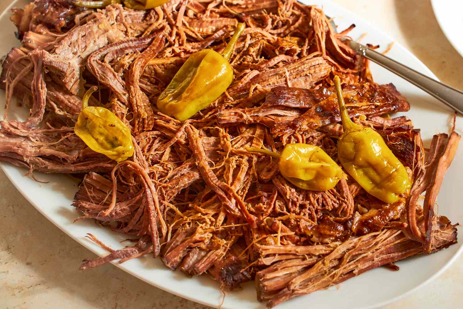 Platter of shredded pot roast with pepperoncinis