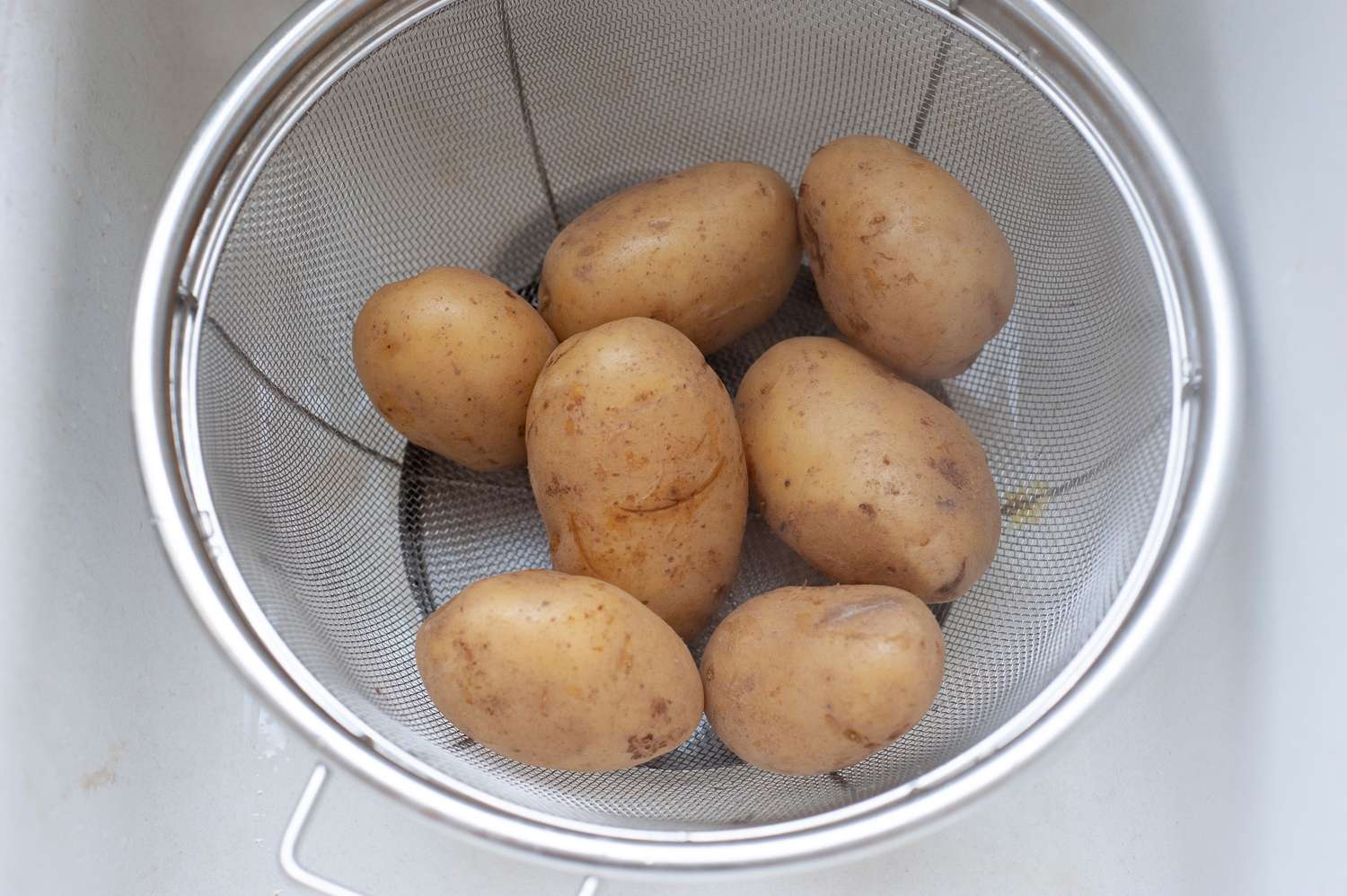 Potatoes in a Sieve for Rosti Recipe