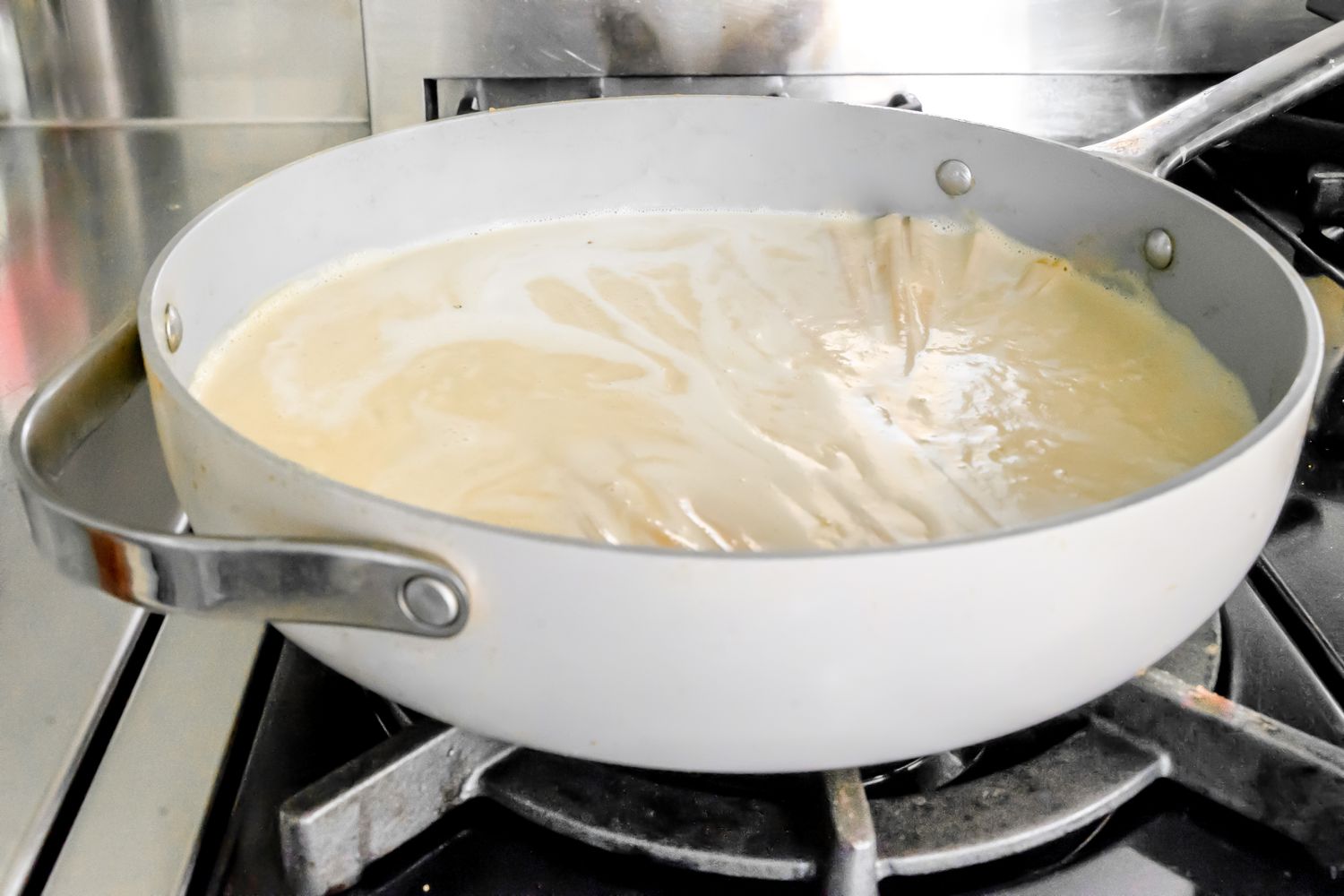 Pasta Boiling in a Pot with the Sauce on a Stove for Vegan Pasta Recipe