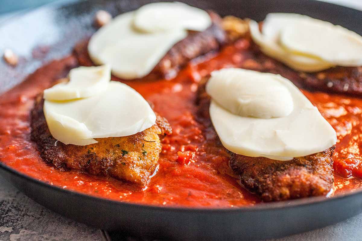 How to Make Chicken Parmesan in a Skillet add the cheese and put the chicken in the oven